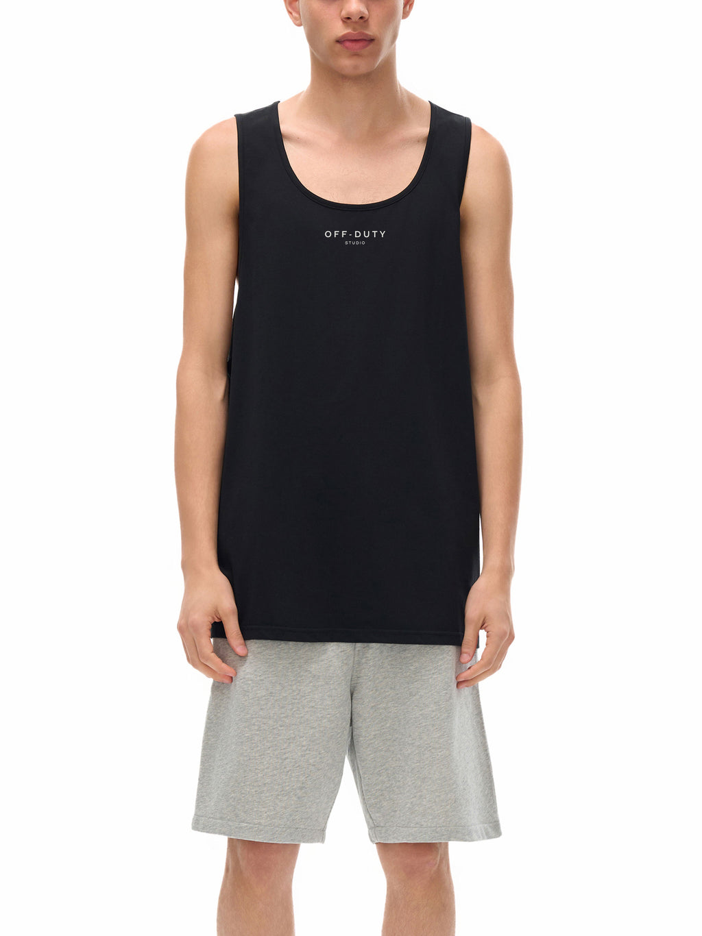 Person wearing a black tank top with 'OFF DUTY' text and gray shorts on a white background