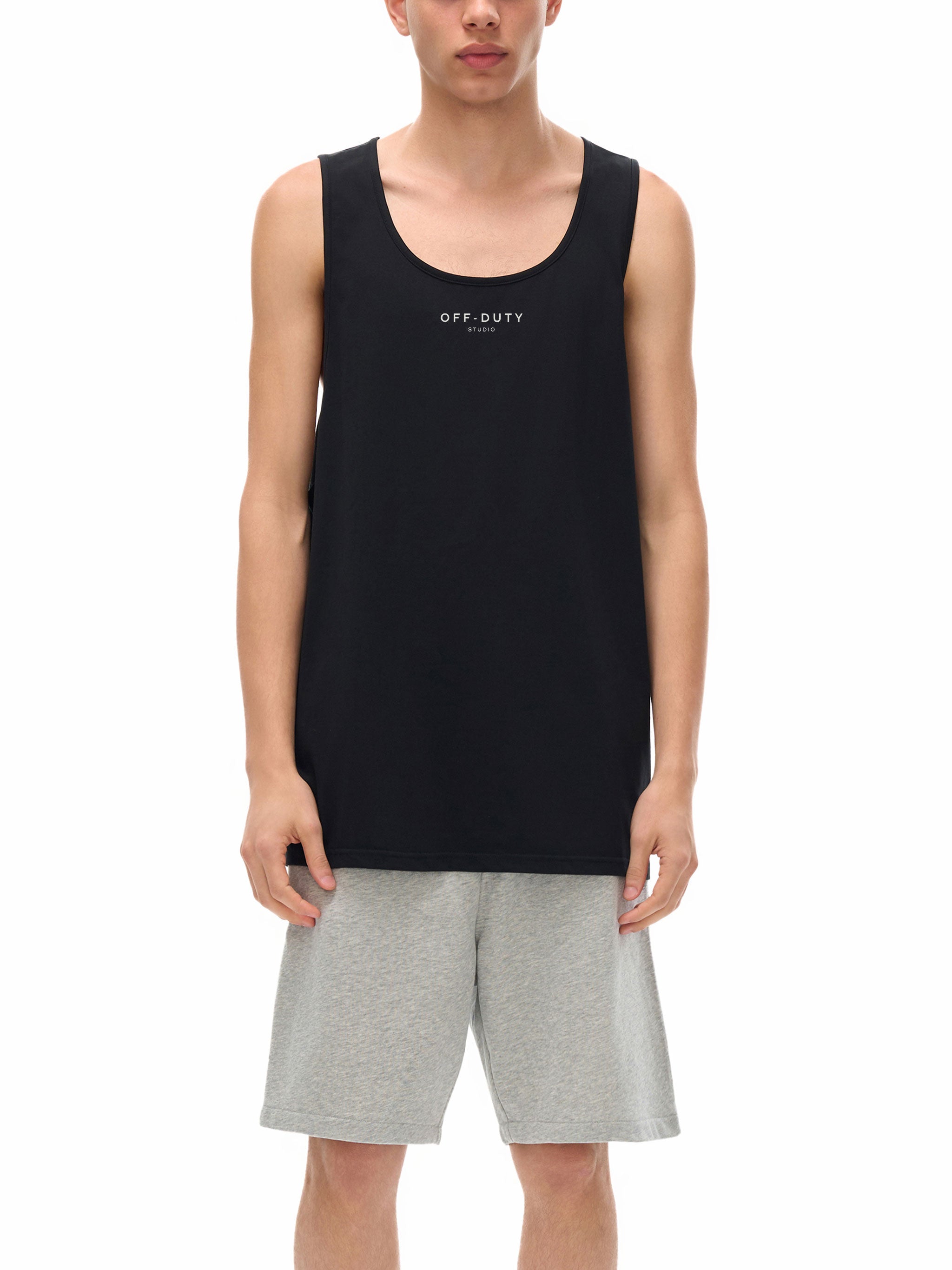 Person wearing a black tank top with 'OFF DUTY' text and gray shorts on a white background